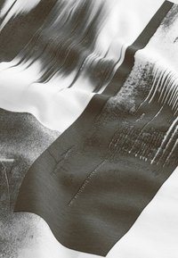 Abstract fabric with smooth, glossy texture; features swirling black and white patterns, with a sharp-edged black section at the bottom.