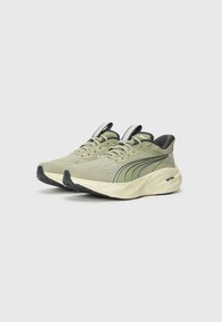 Pair of light green Puma running shoes with cushioned white soles and black accents, positioned side by side on a plain background.