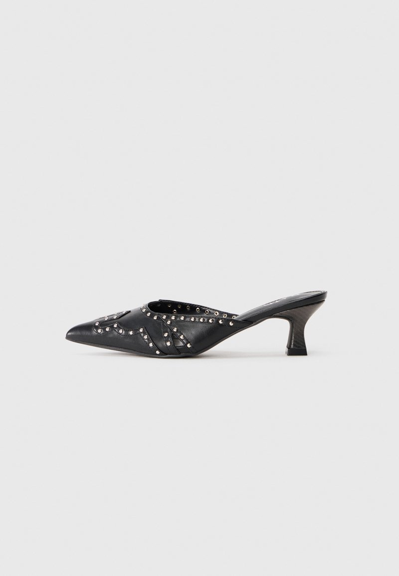 Black leather pointed mule with studded decorative patterns and a short, angled kitten heel.