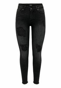 Jeans negros ajustados con desgastes en las rodillas, dobladillo deshilachado y un diseño ceñido. Fabricados en denim con una textura suave.