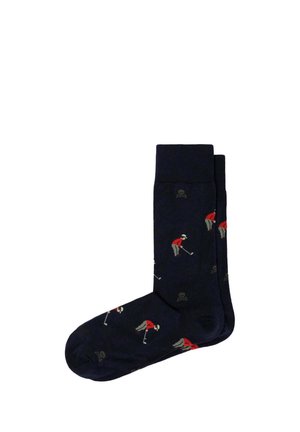 Calcetines azul oscuro con un patrón de golfistas que llevan camisas rojas y pantalones grises sosteniendo palos de golf.