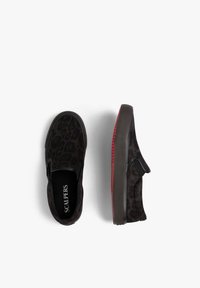 Zapatillas negras sin cordones con un sutil patrón de leopardo y suelas rojas de goma, mostradas desde vistas superior y lateral sobre un fondo blanco.