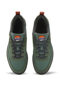 Green canvas sneakers with dark gray accents, flat laces, and a patterned logo on the tongue. Features a textured black rubber sole.