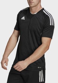Black athletic shirt with textured geometric pattern, short sleeves, and white Adidas stripes on shoulders. Made from breathable material.
