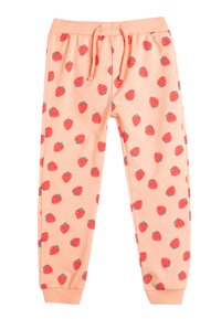 Pantalones de chándal en color durazno claro con un estampado repetido de fresas, cinturilla elástica con cordón y puños acanalados. Tejido de algodón suave.