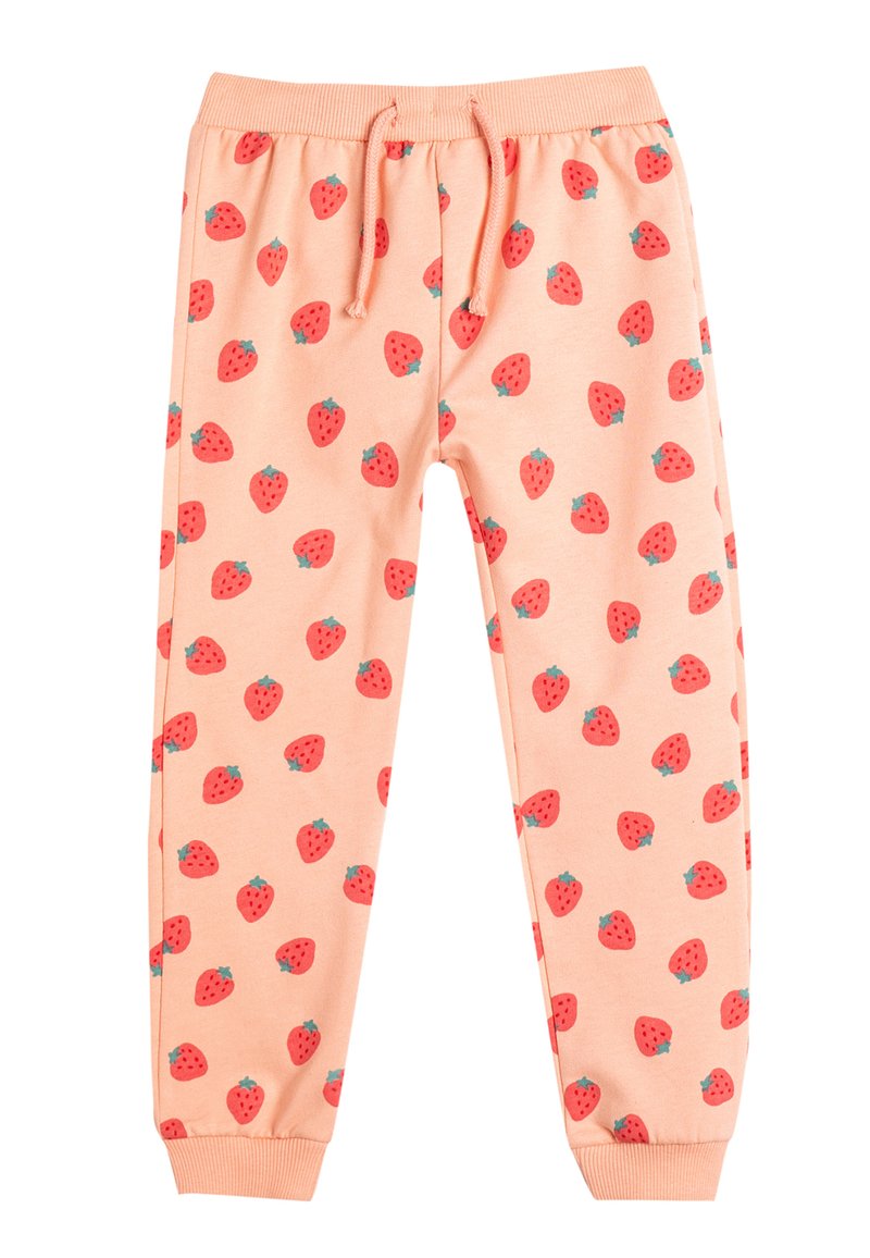 Pantalones de chándal en color durazno claro con un estampado repetido de fresas, cinturilla elástica con cordón y puños acanalados. Tejido de algodón suave.