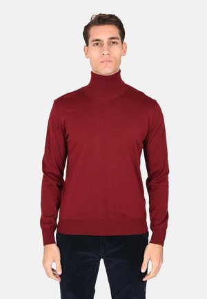 Maglione a collo alto color bordeaux realizzato in un tessuto morbido, con maniche lunghe e un design aderente. Presenta polsini e orlo a coste.