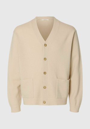 Cardigan a maglia beige con scollo a V, chiusura anteriore con bottoni e due tasche laterali. Presenta un tessuto texturizzato e polsini a costine.