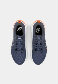 Navy running shoes with a textured mesh upper, white midsole, orange accents, and six eyelets for laces. Signature logo on the tongue.