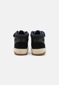 High-top sneakers with a black suede upper, blue accents, and a beige rubber sole. Features a velcro strap and textured back.