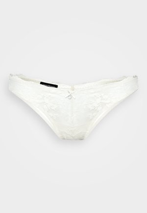 String en dentelle blanche avec motif floral, nœud décoratif à l'avant et texture douce. Ceinture élastique et bords lisses pour plus de confort.