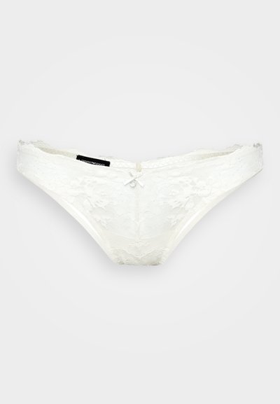 White lace thong with floral pattern, decorative bow at front, and soft texture. Elastic waistband and smooth edges for comfort.