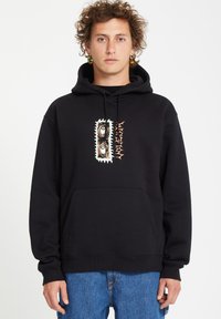 Zwarte hoodie met een voorzak, voorzien van een kleurrijk grafisch ontwerp van ogen en patronen op de borst. Van katoen, ruime pasvorm.