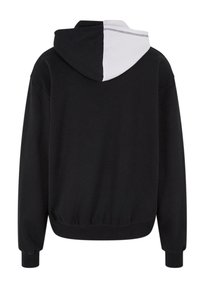 Zwarte hoodie met een contrasterend wit paneel op de capuchon. Voorzien van elastische manchetten en zoom, gemaakt van een zachte stof met een relaxte pasvorm.