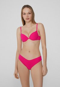 Helles pinkes Bikini-Set mit leicht gepolstertem BH und verstellbaren Trägern sowie passendem, niedrig geschnittenem Höschen, gefertigt aus glattem, elastischem Material.