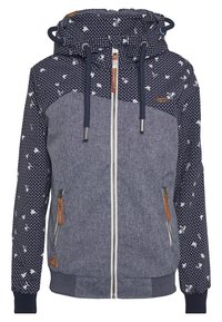 Sweat à capuche zippé bleu marine avec un corps texturé et tacheté et des manches à pois. Comprend une capuche à cordon de serrage et des accents en cuir.