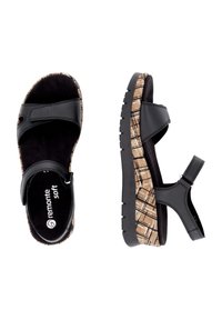 Sandales noires avec une semelle en liège texturé et un talon compensé, dotées d'une sangle adjustable. Semelle de pied en suède doux et semelle en caoutchouc pour une meilleure traction.