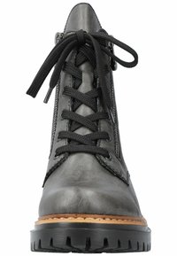 Bottine noire en cuir avec un devant à lacets, des zips sur les côtés, une semelle intermédiaire beige et une semelle en caoutchouc texturé.