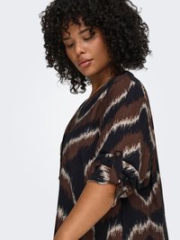 Brown patterned blouse with short rolled sleeves. Features an abstract design in cream and navy. Lightweight, textured fabric.