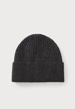 Black ribbed knit beanie with a folded cuff, featuring a small embossed logo on the side. Soft texture, rounded top shape.