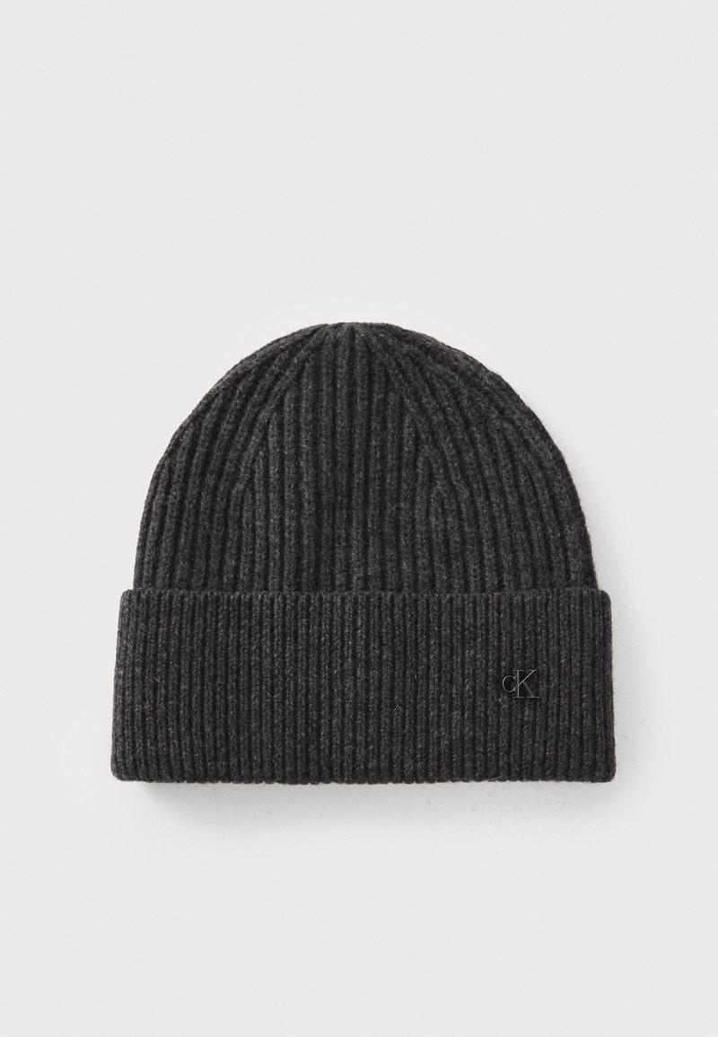 Black ribbed knit beanie with a folded cuff, featuring a small embossed logo on the side. Soft texture, rounded top shape.
