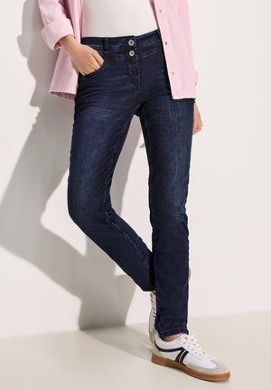 Dark denim jeans with a slim fit, featuring a high waist, two-button closure, front pockets, and subtle fading. Paired with white sneakers.