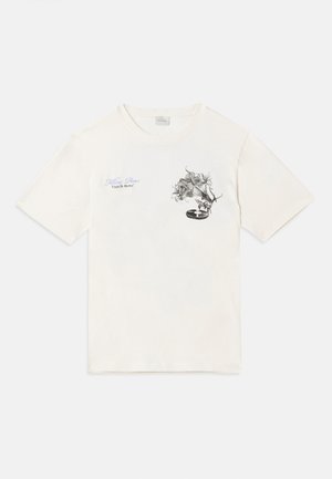 Lys beige bomull t-skjorte med et grafisk design av blomster og en platespiller, med tekst i blått og svart. Rund hals og korte ermer.