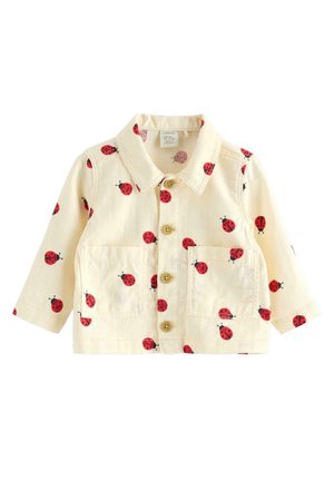 Hellcremefarbene Kinderjacke mit rotem Marienkäferdruck, Knöpfen vorne, Kragen, langen Ärmeln und zwei Brusttaschen.