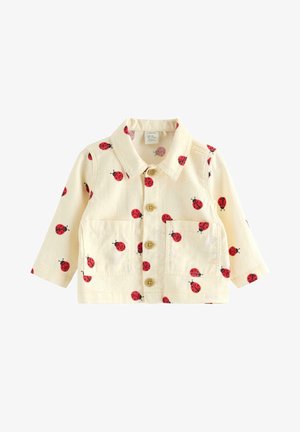 Hellcremefarbene Kinderjacke mit rotem Marienkäferdruck, Knöpfen vorne, Kragen, langen Ärmeln und zwei Brusttaschen.
