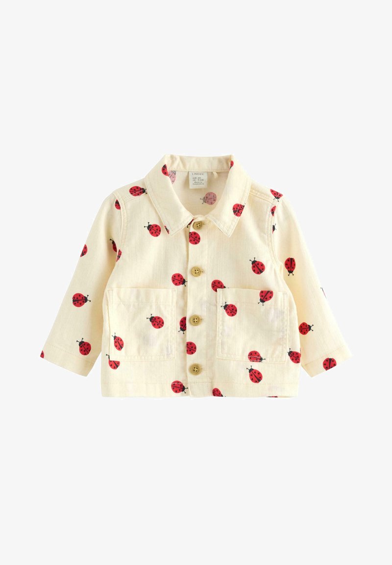 Μπουφάν για νήπια σε κρεμ χρώμα με κόκκινο σχέδιο πασχαλίτσας, με κουμπιά στο μπροστινό μέρος, γιακά, μακριά μανίκια και δύο τσέπες στο στήθος.