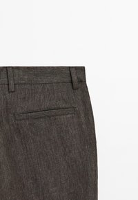 Dark grey trousers with a subtle texture, featuring a standard waistband and a single pocket at the back, stitched in contrasting thread.