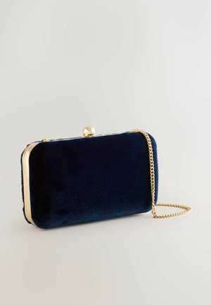 Navy velvet clutch bag with a gold-tone frame, a decorative clasp, and a detachable chain strap. Smooth texture and compact rectangular shape.