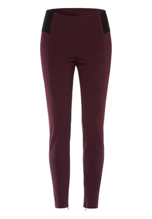 Burgundy pants with a fitted design. Features a black waistband and a smooth texture, with zippers at the ankle for added detail.