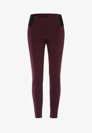 Burgundy pants with a fitted design. Features a black waistband and a smooth texture, with zippers at the ankle for added detail.