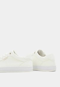 Weiße Sneaker aus glattem Leder, mit rundem Zehenbereich, flachem Schnürdesign und einer strukturierten Gummisohle. Dezentes Markenlogo an der Seite.