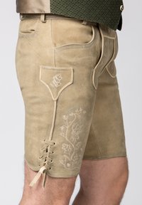 Tan leren shorts met zijborduursels, voorzien van een voorzak, kantdetails aan de zoom en een gladde, gestructureerde afwerking.