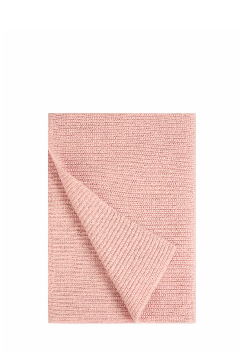 Coperta di cotone di colore rosa chiaro con un design a maglia testurizzata. Un angolo è piegato per rivelare il lato liscio sottostante.