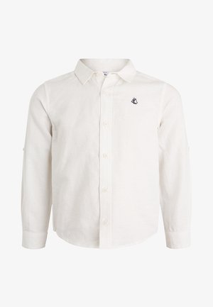 Camicia bianca a maniche lunghe in tessuto strutturato con chiusura frontale a bottoni, presenta un piccolo logo nero a forma di veliero sul petto a sinistra.