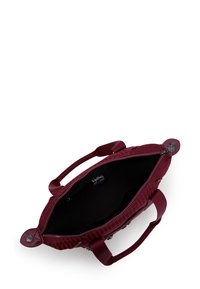 Burgundy handbag with a textured surface, two sturdy handles, zip closure, and an interior label. The design features a geometric pattern.