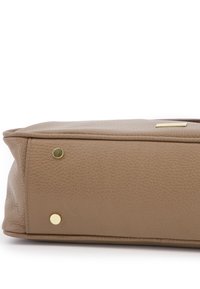 Brown leather bag with a textured surface, featuring gold-tone hardware at the base, rounded corners, and a small logo plate.