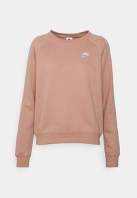 Långärmad crewneck-tröja i dämpad rosa med vit Nike-logga på vänster bröst, ribbade ärmslut och midja.