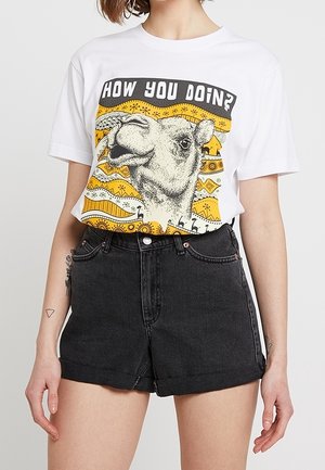White cotton T-shirt featuring a graphic of a camel's face with the text "HOW YOU DOIN?" against a yellow and orange patterned background.