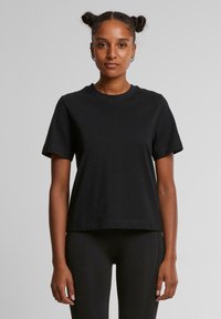 Zwarte katoenen t-shirt met een ronde hals en korte mouwen, met een ontspannen pasvorm en een gladde textuur. Geen zichtbare patronen of accenten.