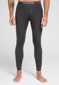 Leggings térmicos de color gris oscuro con un diseño ajustado, cinturilla elástica que presenta el texto "DOVRE" y detalles de puños acanalados. Textura suave.