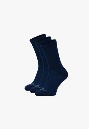Marineblaue Crew-Socken im Rippdesign, aus weichem Material gefertigt. Drei Paare werden präsentiert, mit Logos an den Bündchen.