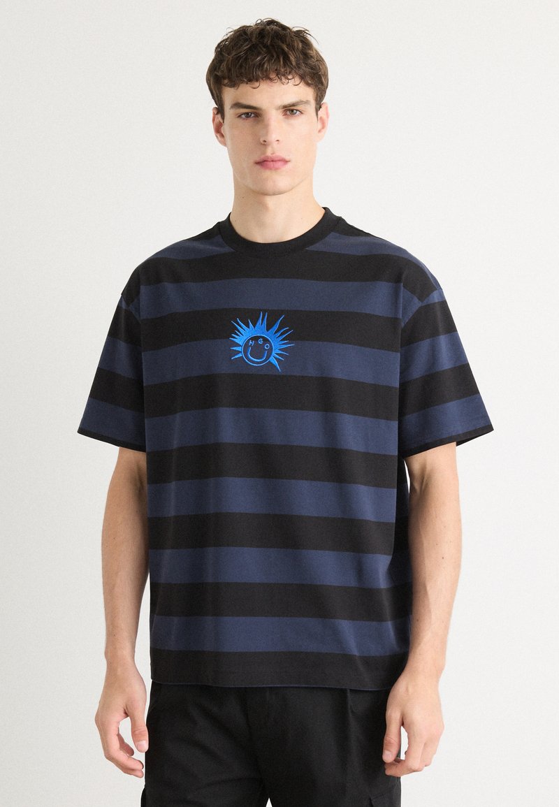 Navy and black striped cotton T-shirt with a round neck and short sleeves; features a blue graphic sun and smile design on the chest.