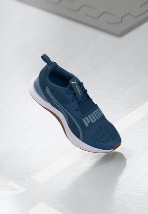 Blue athletic shoes with mesh upper, rubber sole, and cushioned midsole. Features prominent white logo and yellow accent on the tongue.
