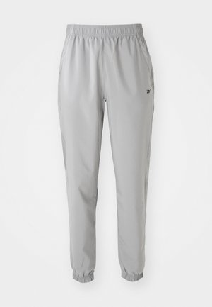 Lys grå joggebukser laget av lett stoff, med elastisk midje, ribbet ankler og sidelommer. Diskret merkevaredetalj.