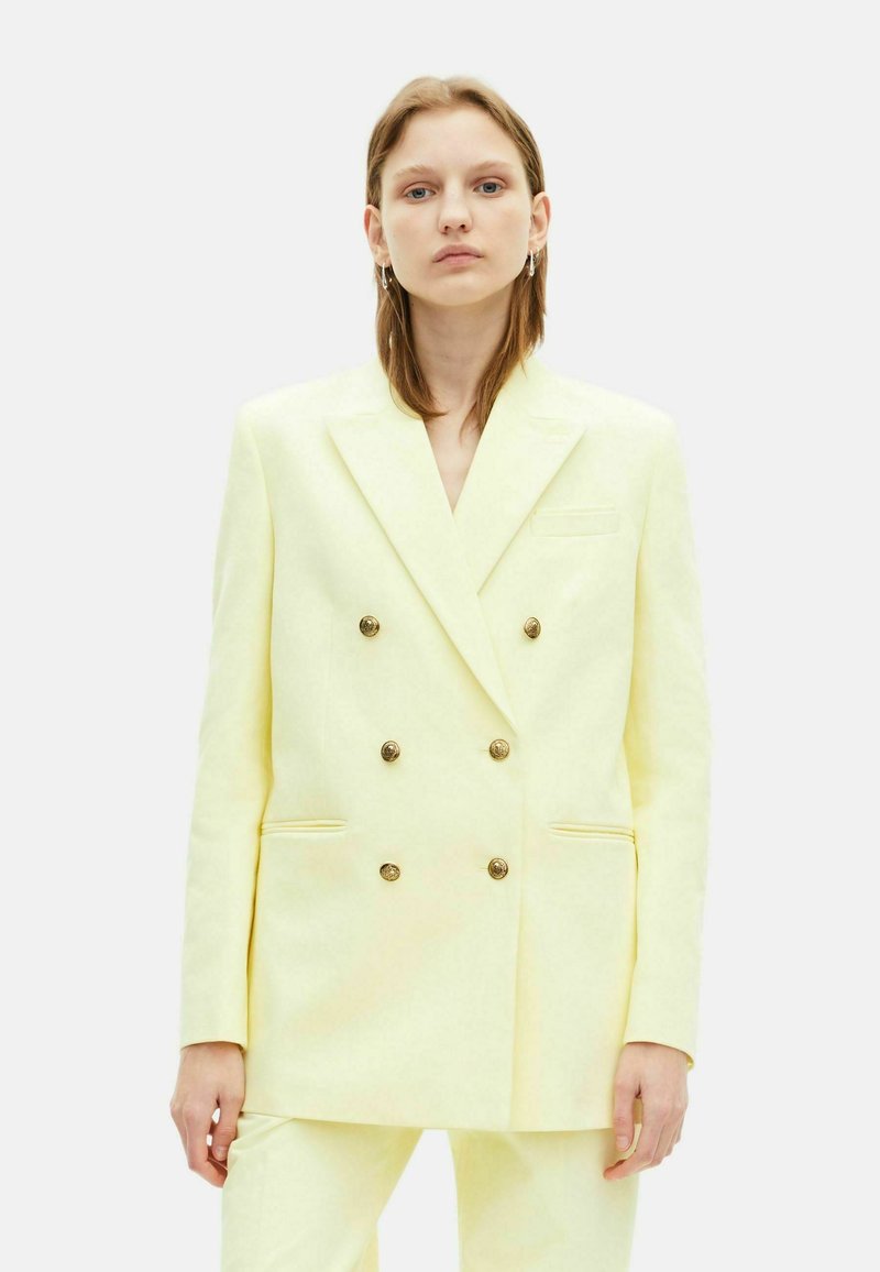 Dubbelzijdig blazer in lichtgele stof, met gouden knopen, notch-lapels en zijzakken voor een perfecte pasvorm.