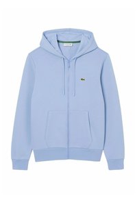 Hoodie zippé bleu clair en tissu lisse avec une poche kangourou à l'avant, des poignets côtelés et un logo brodé en vert.